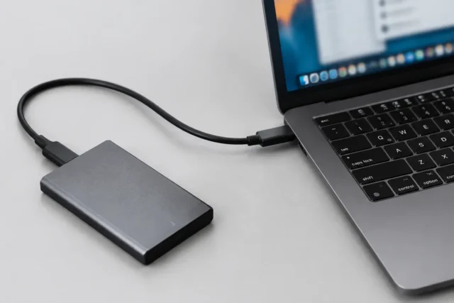 SSD-накопитель и компьютерные комплектующие на светло-сером фоне без людей и текста